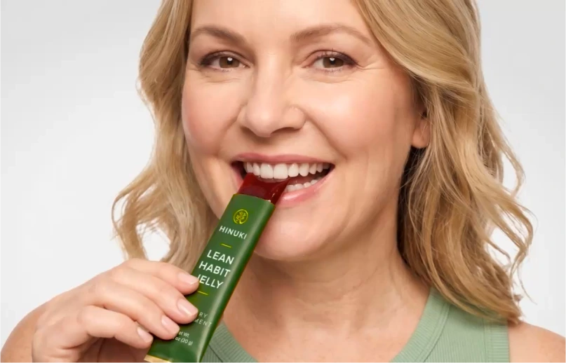 Woman eating a Hinuki jelly stick after lunch instead of dessert