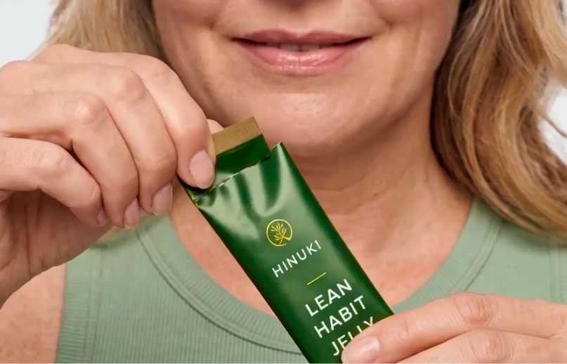Hands tearing open a Hinuki jelly stick at the notch